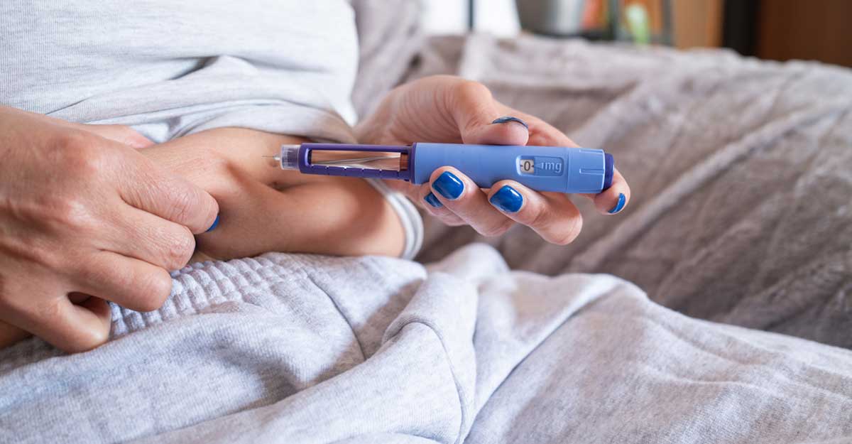 up close shot of a person using a GLP-1 pen