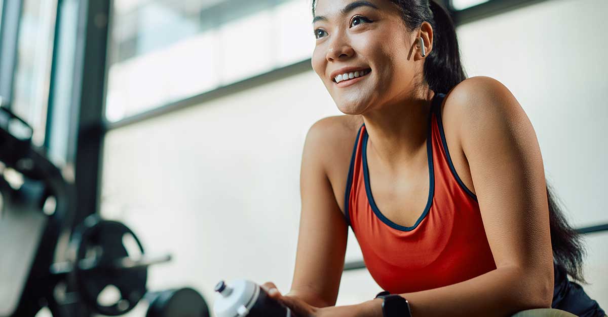 young woman resting between sets at the gym