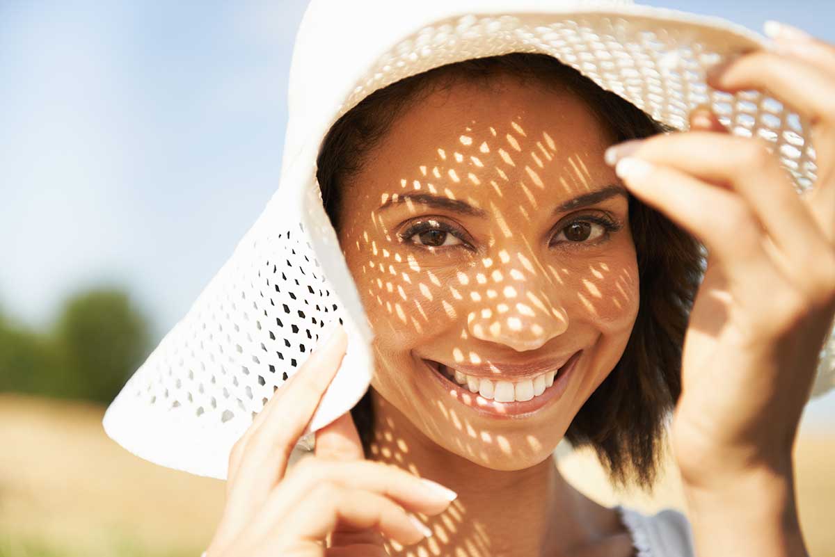 smiling woman in floppy sun hat smiling woman in floppy sun hat